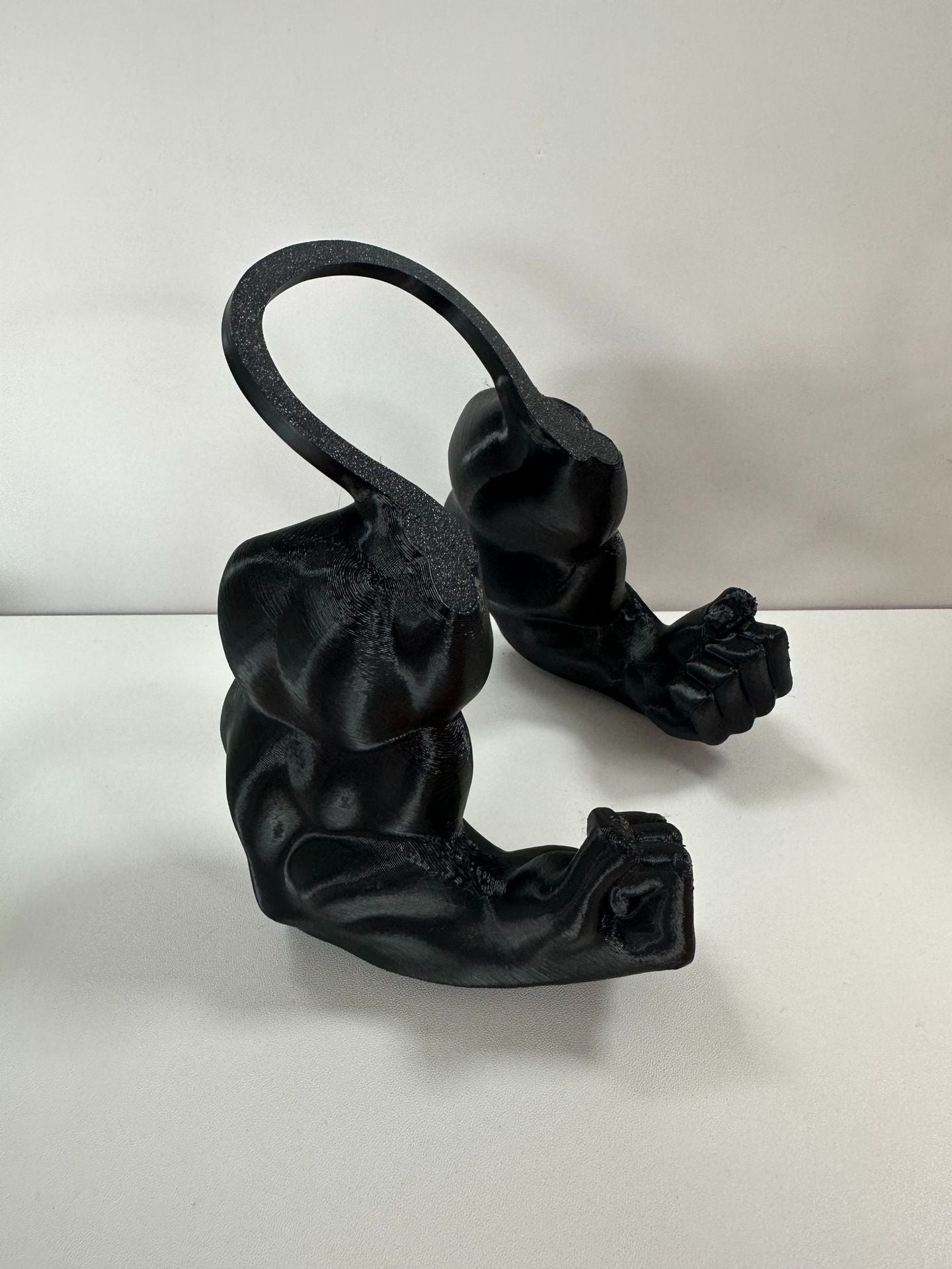Muezza shoppe black pet decorative halter toy shaped like muscular arms with clenched fists